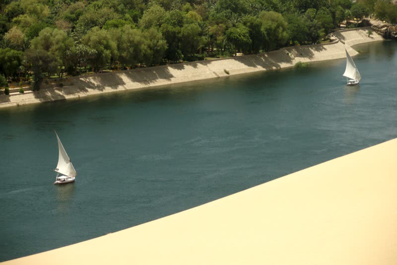 Feluccas moving through the Aswan river landscape